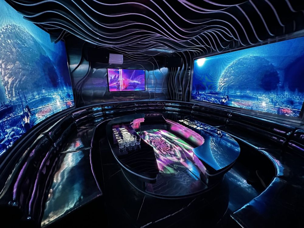 A 70m² karaoke room for 30 guests in District 1, Ho Chi Minh City — sofas arranged around the banquet table